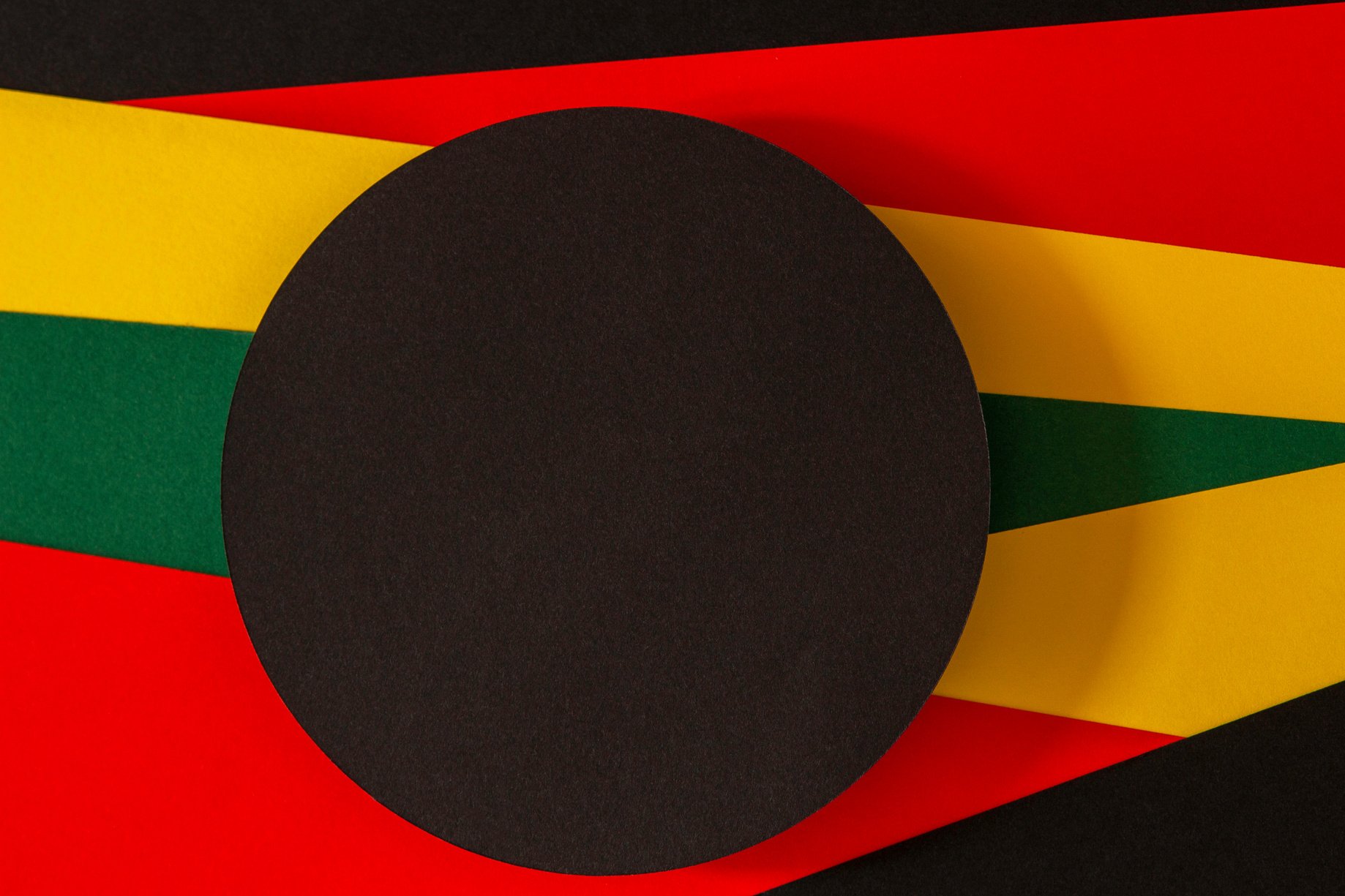 Black History Month Color Background. Blank Black Circle on Geometric Red, Yellow, Green Color Background. Top View